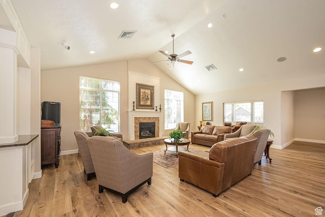 1886 S 830 W Unit D, Syracuse, UT 84075 - living room with lofted ceiling, visible vents, light wood-style flooring, a glass covered fireplace, and ceiling fan