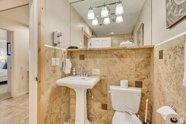 255 Main St Unit A2, Park City, UT 84060 - full bathroom with tile walls, walk in shower, toilet, tile patterned floors, and ensuite bath