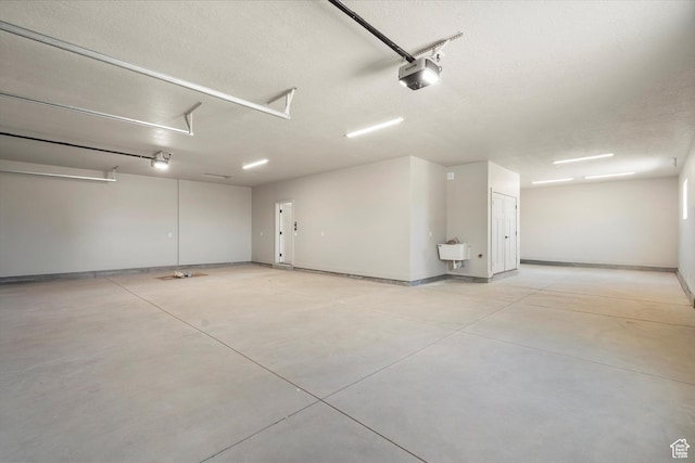 2833 N 3475 W, Plain City, UT 84404 - garage featuring baseboards and a garage door opener