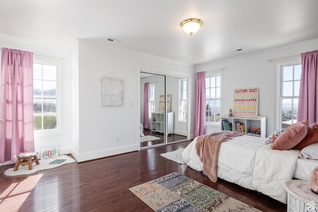67 E Dorchester Dr, Salt Lake City, UT 84103 - bedroom featuring a closet, dark wood-style flooring, visible vents, baseboards, and ornamental molding