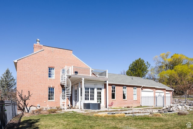67 E Dorchester Dr, Salt Lake City, UT 84103 - rear view of house featuring a balcony, fence, a chimney, brick siding, and a lawn