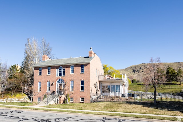 67 E Dorchester Dr, Salt Lake City, UT 84103 - view of front of house with a front lawn, a chimney, fence, and a mountain view