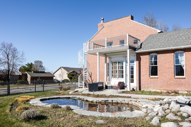 67 E Dorchester Dr, Salt Lake City, UT 84103 - back of property with stairs, a patio area, fence, brick siding, and a balcony