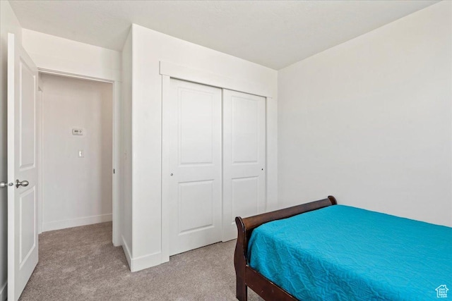 379 S Utah Dr, Grantsville, UT 84029 - bedroom with light colored carpet, a closet, and baseboards