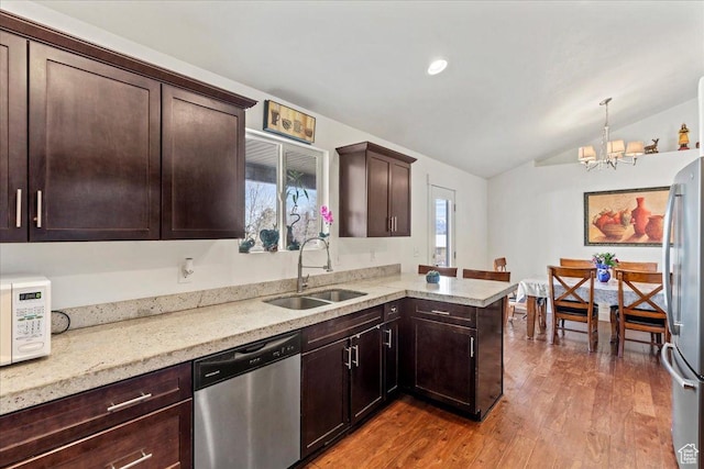 379 S Utah Dr, Grantsville, UT 84029 - kitchen featuring a notable chandelier, stainless steel appliances, a sink, dark brown cabinets, and wood finished floors