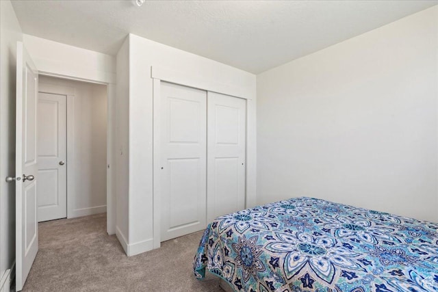 379 S Utah Dr, Grantsville, UT 84029 - bedroom with baseboards, a closet, and light colored carpet
