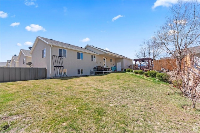 379 S Utah Dr, Grantsville, UT 84029 - back of house featuring a yard, a pergola, stucco siding, and fence