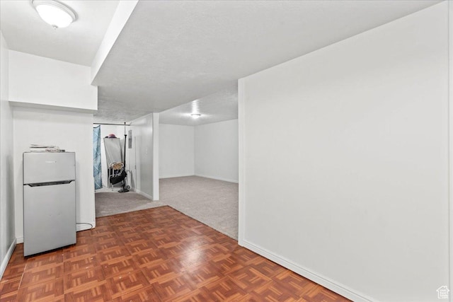 379 S Utah Dr, Grantsville, UT 84029 - finished basement with baseboards, a textured ceiling, and freestanding refrigerator