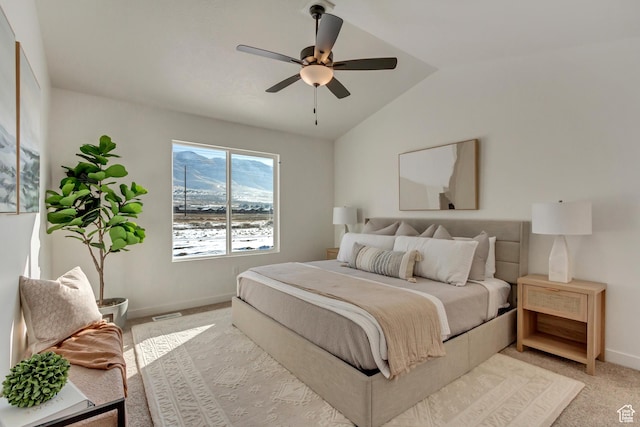 bedroom with light carpet, baseboards, vaulted ceiling, and ceiling fan