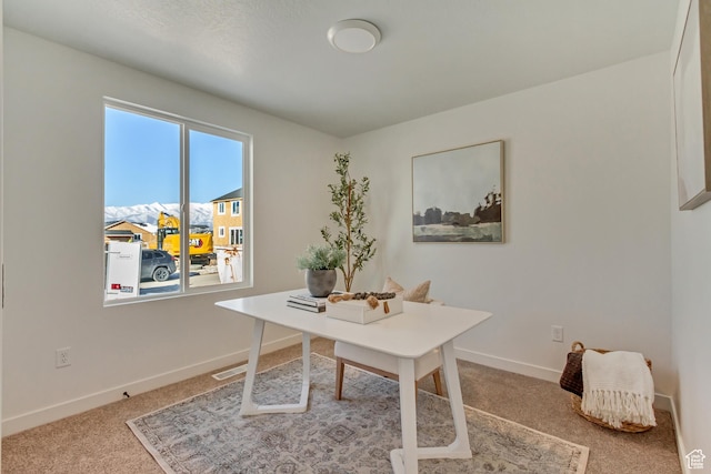 carpeted office space featuring baseboards and visible vents