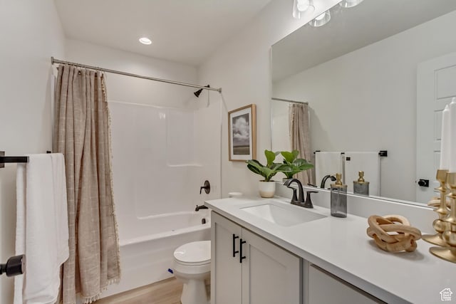 full bath featuring wood finished floors, toilet, vanity, and shower / bathtub combination with curtain