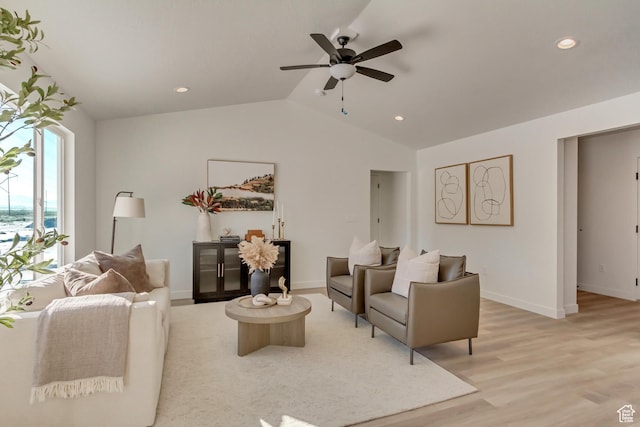 living area with vaulted ceiling, a ceiling fan, light wood-style flooring, baseboards, and recessed lighting