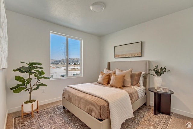 carpeted bedroom featuring baseboards