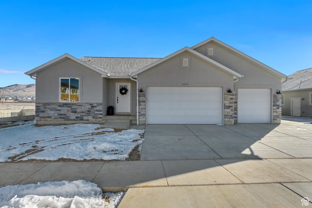ranch-style home featuring stone siding, concrete driveway, stucco siding, and an attached garage