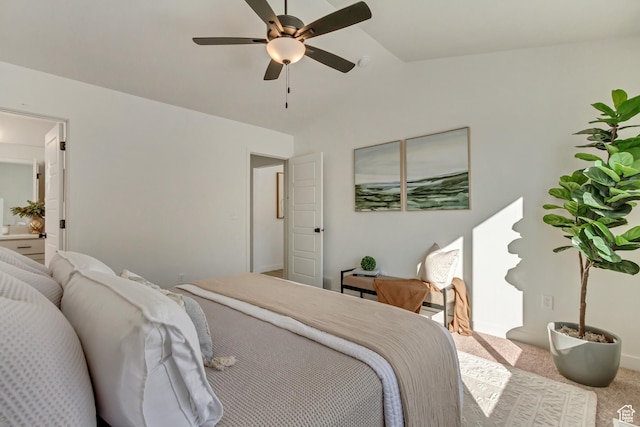 carpeted bedroom featuring a ceiling fan and vaulted ceiling