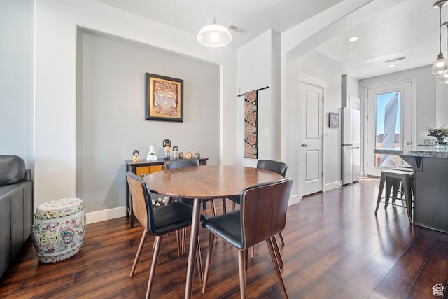 dining space featuring dark wood-type flooring, visible vents, baseboards, and recessed lighting