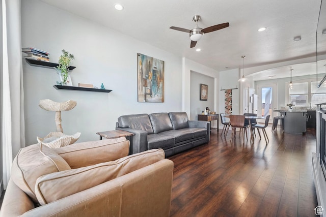 living room featuring ceiling fan, recessed lighting, and dark wood finished floors