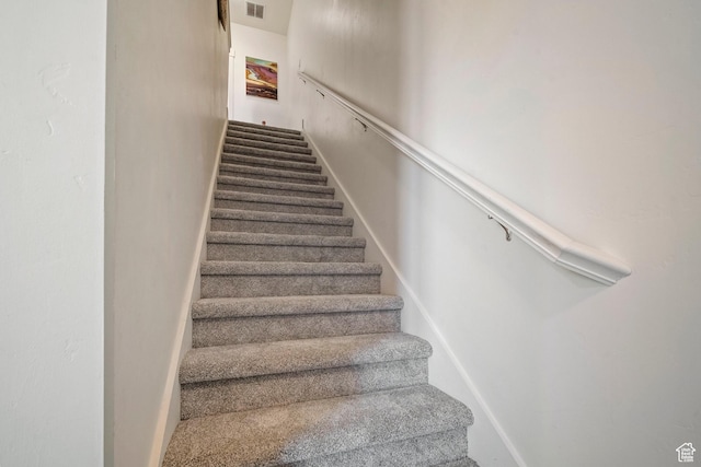 stairway featuring visible vents