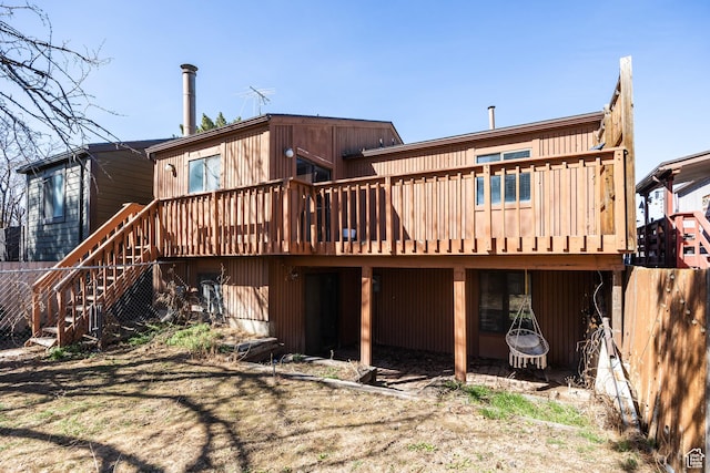 rear view of house featuring a deck and stairway