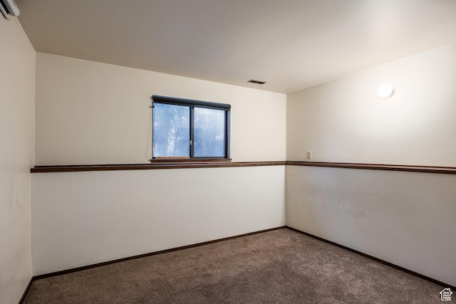 unfurnished room featuring carpet flooring, baseboards, and visible vents