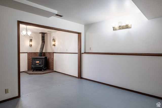 interior space with baseboards, a wood stove, and visible vents