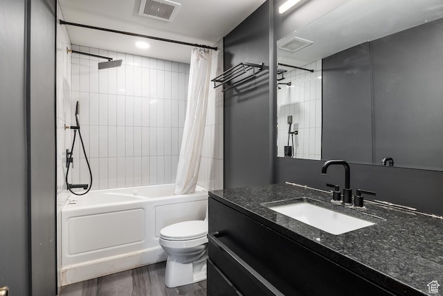 full bathroom with visible vents, shower / bath combo with shower curtain, toilet, and vanity