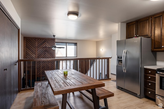 kitchen featuring light countertops, dark brown cabinetry, a ceiling fan, appliances with stainless steel finishes, and light wood-style floors