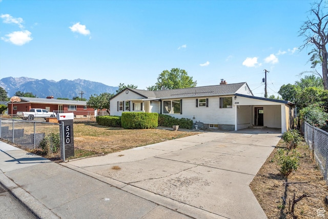 520 E Locust St S, Sandy, UT 84070 - ranch-style home featuring fence, a chimney, driveway, a mountain view, and a carport