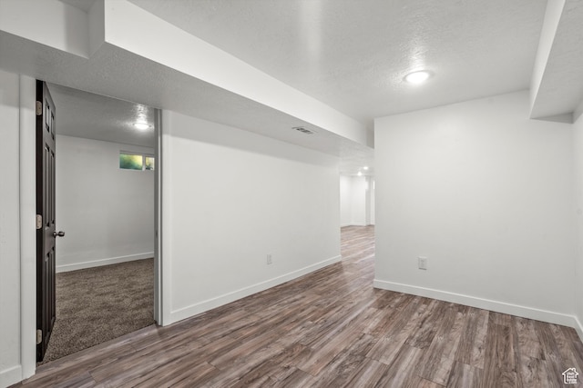 520 E Locust St S, Sandy, UT 84070 - finished basement featuring visible vents, a textured ceiling, baseboards, and wood finished floors