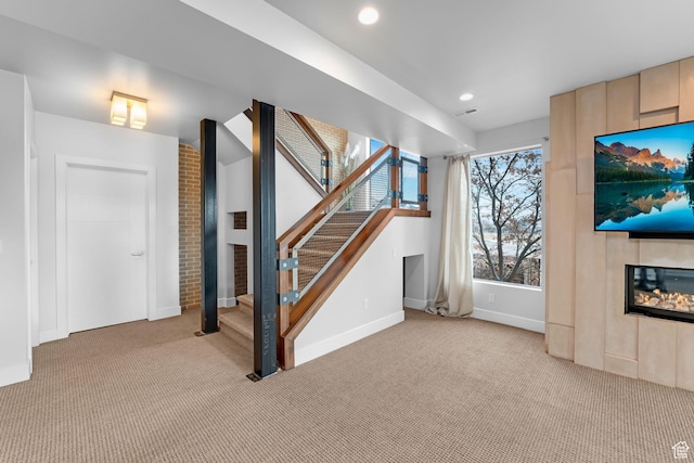 4601 N Toscana Hills Dr, Lehi, UT 84043 - unfurnished living room with a large fireplace, light carpet, stairway, and recessed lighting