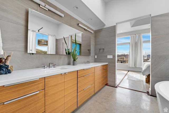 4601 N Toscana Hills Dr, Lehi, UT 84043 - full bathroom with double vanity, a sink, concrete floors, and a freestanding bath