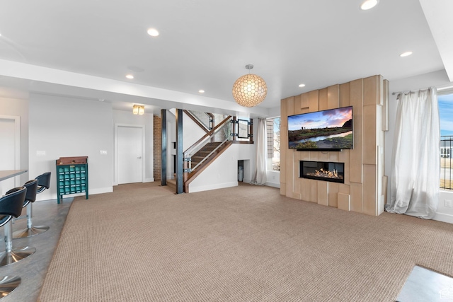 4601 N Toscana Hills Dr, Lehi, UT 84043 - carpeted living area with a large fireplace, baseboards, stairs, and recessed lighting