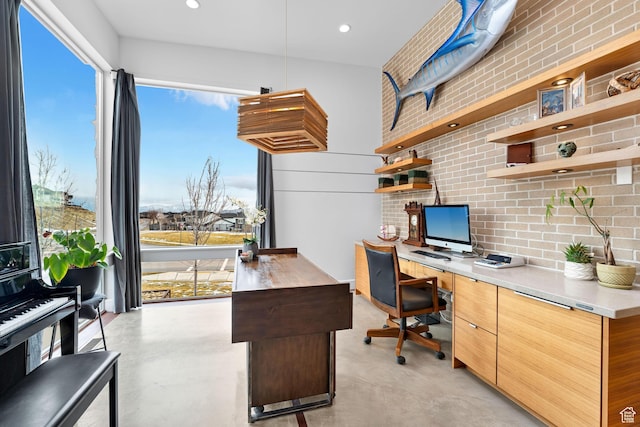 4601 N Toscana Hills Dr, Lehi, UT 84043 - office area featuring concrete flooring, built in study area, recessed lighting, and brick wall