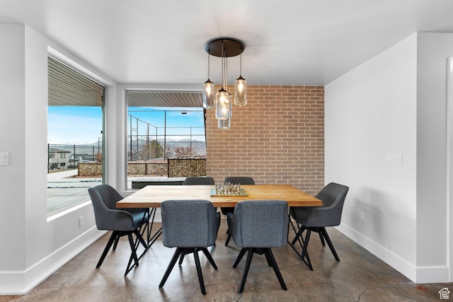 4601 N Toscana Hills Dr, Lehi, UT 84043 - dining space featuring baseboards, brick wall, and finished concrete floors