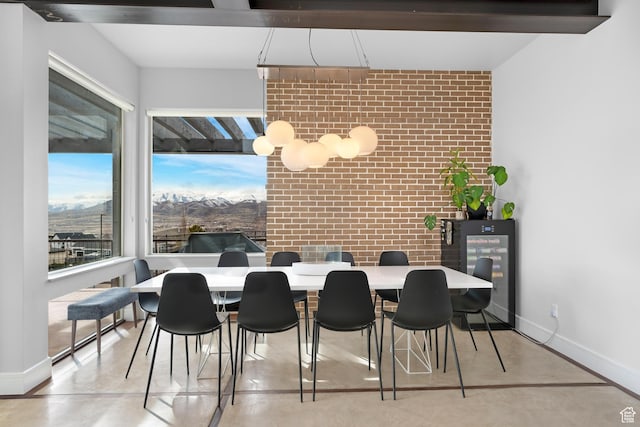 4601 N Toscana Hills Dr, Lehi, UT 84043 - dining space featuring finished concrete flooring, baseboards, brick wall, and an accent wall