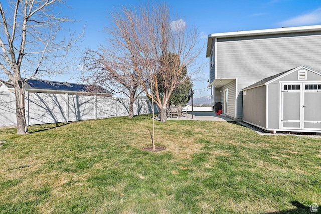 6874 S Hoyle Cir, West Jordan, UT 84081 - view of yard with an outdoor structure, a shed, fence, and a patio area