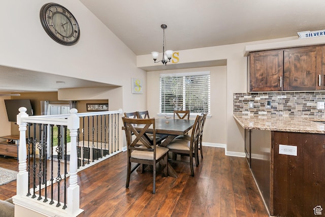 6874 S Hoyle Cir, West Jordan, UT 84081 - dining area with baseboards, dark wood-style flooring, vaulted ceiling, and a chandelier