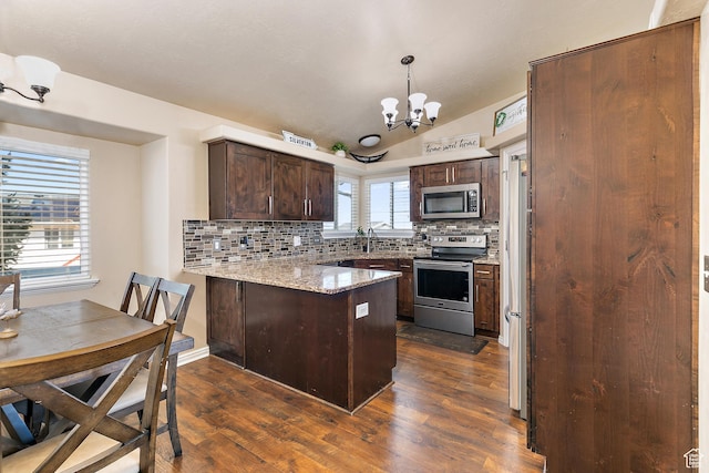 6874 S Hoyle Cir, West Jordan, UT 84081 - kitchen featuring a peninsula, stainless steel appliances, dark brown cabinets, dark wood-type flooring, and an inviting chandelier