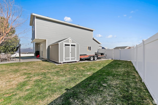 6874 S Hoyle Cir, West Jordan, UT 84081 - exterior space featuring a storage unit, a fenced backyard, an outdoor structure, and a patio area