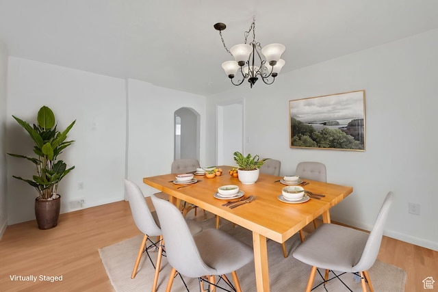 150 E 200 S, Providence, UT 84332 - dining room with a chandelier, arched walkways, light wood-style floors, and baseboards
