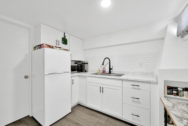 150 E 200 S, Providence, UT 84332 - kitchen with tasteful backsplash, freestanding refrigerator, white cabinets, light stone countertops, and a sink