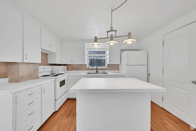 150 E 200 S, Providence, UT 84332 - kitchen featuring white appliances, light wood-style floors, a sink, and a kitchen island