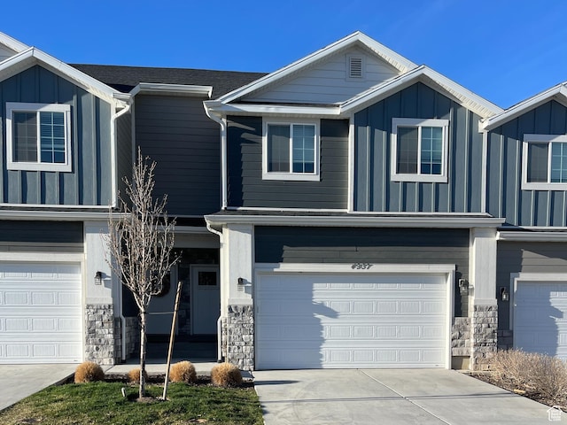 4937 E Lake Dr, Eagle Mountain, UT 84005 - view of front of property with stone siding, driveway, a garage, and board and batten siding