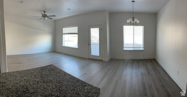 4937 E Lake Dr, Eagle Mountain, UT 84005 - unfurnished dining area featuring baseboards, wood finished floors, a healthy amount of sunlight, and ceiling fan with notable chandelier