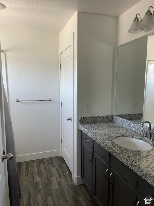 4937 E Lake Dr, Eagle Mountain, UT 84005 - bathroom featuring baseboards, wood finished floors, and vanity