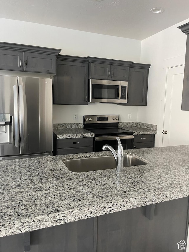 4937 E Lake Dr, Eagle Mountain, UT 84005 - kitchen featuring a sink, stainless steel appliances, and light stone counters