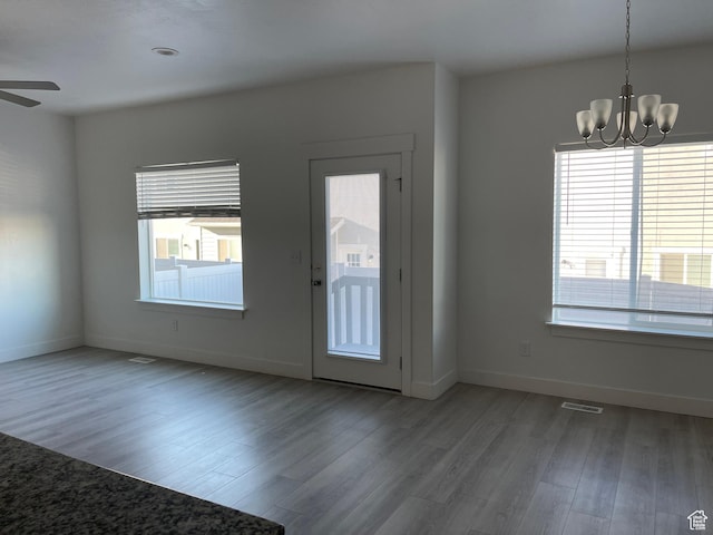 4937 E Lake Dr, Eagle Mountain, UT 84005 - foyer entrance featuring baseboards, wood finished floors, and ceiling fan with notable chandelier