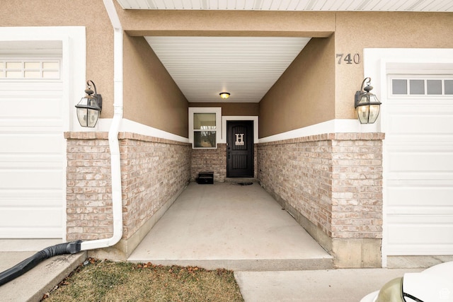 740 S 70 E, Smithfield, UT 84335 - doorway to property featuring stucco siding, brick siding, and a garage