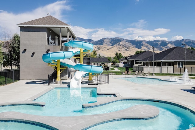 740 S 70 E, Smithfield, UT 84335 - pool with fence, a hot tub, a patio, a water slide, and a mountain view