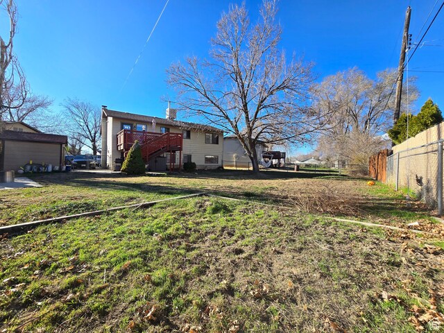 243 Downs Cir, Ogden, UT 84404 - view of yard featuring a wooden deck and fence
